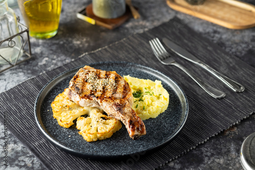 Grilled pork chop with mashed potatoes and roasted cauliflower