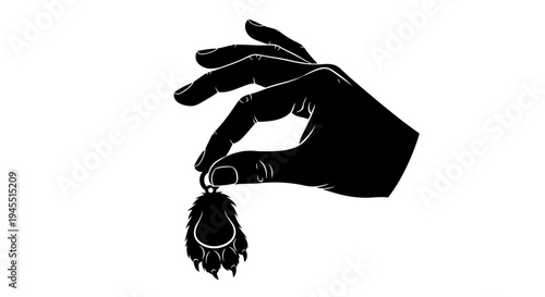 Hand Holding a Decorative Paw Print Keychain Silhouette.
