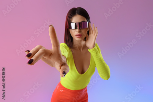 Young woman in VR glasses u...