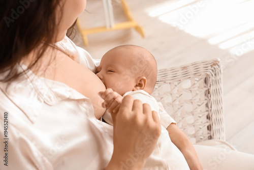 Young woman breastfeeding h...