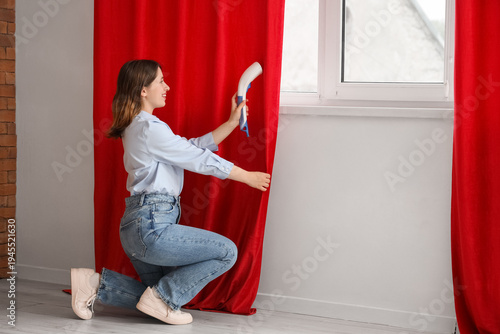Young woman steaming red cu...