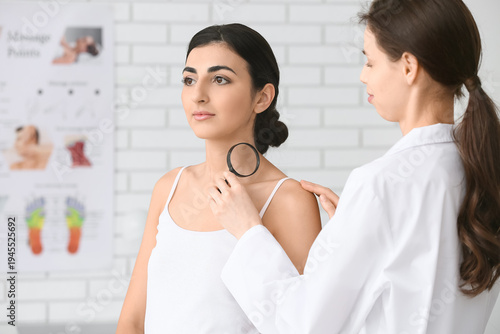 Dermatologist with magnifyi...