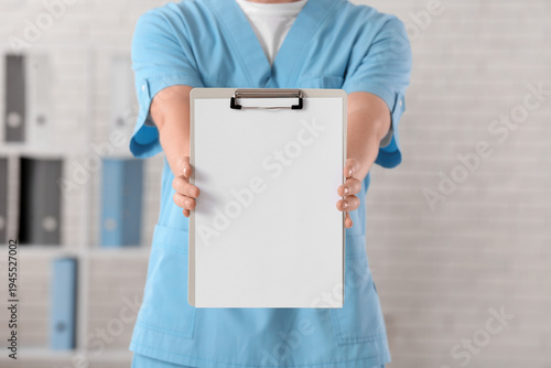 Male doctor holding blank c...