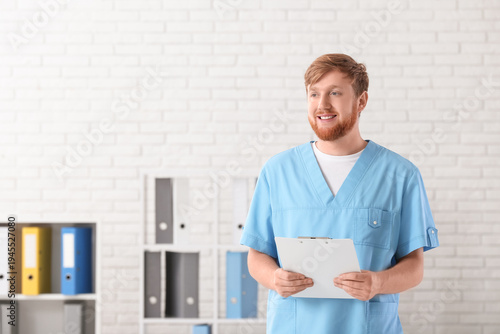 Young male doctor with clip...