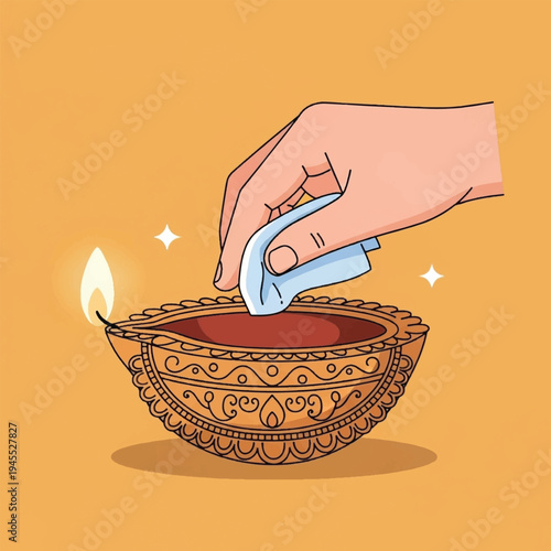 Hand lighting diya oil lamp flame.