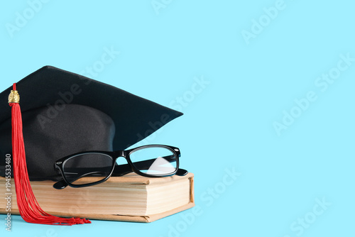 Graduation hat, book and gl...