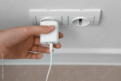 Female hand unplugging char...