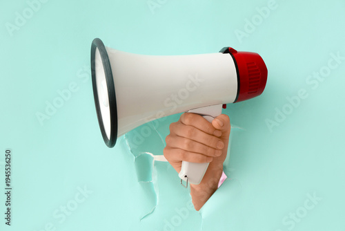 Female hand with megaphone ...