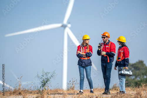 engineer team inspection check control wind power machine construction installation in wind energy factory. technician professional worker discussion check for maintenance electronic wind turbine