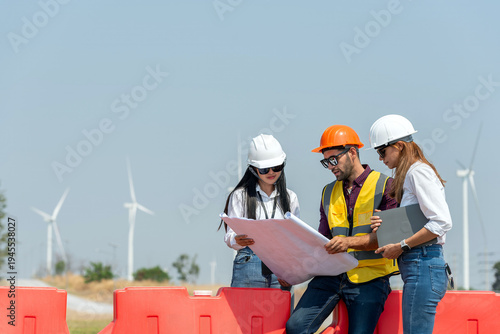 engineer team inspection check control wind power machine construction installation in wind energy factory. technician professional worker discussion check for maintenance electronic wind turbine