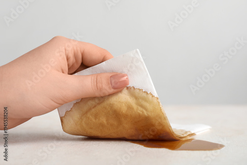 Woman wiping spilled coffee...