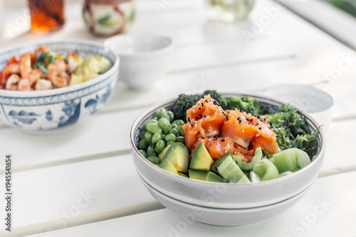 smoked salmon and green vegetable healthy poke bowl on white table in melbourne australia cafe