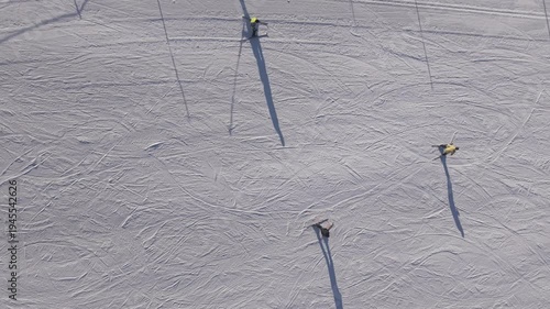 Aerial view of cross country skiers moving on snowy field in winter