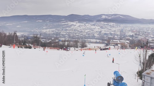 Drone following two skiers racing parallel slalom on snowy mountain competition slope