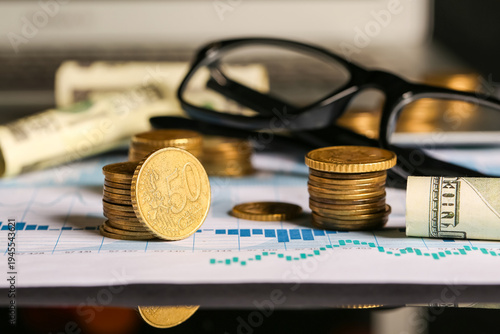 Golden coins with eyeglasse...