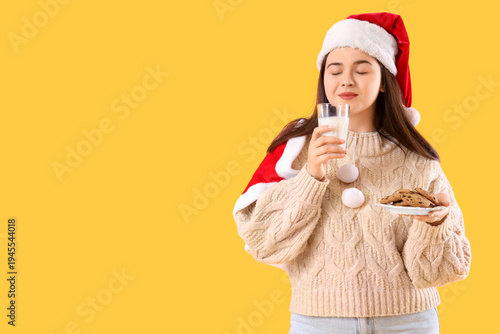 Young woman in Santa hat wi...