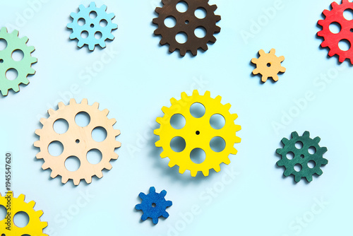 Wooden gears on light blue ...