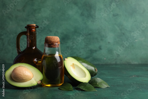Schilderij op canvas Bottle and jug of avocado oil on green background