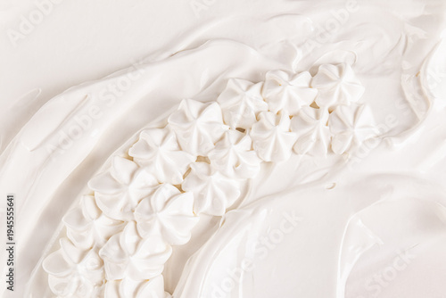 delicate white roses of cream on the background of vanilla buttercream texture. top view. A sample of a decoration made of cream. selective focus