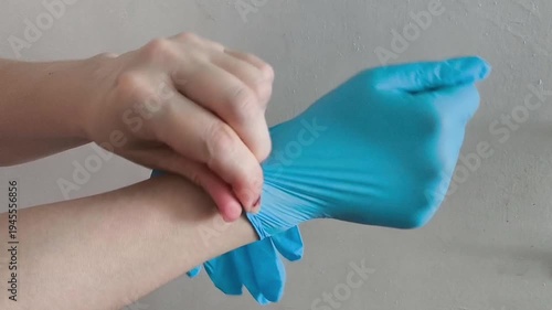 Hands are wearing blue medical gloves on a white background. Sterility. Sanitary standards. Protection