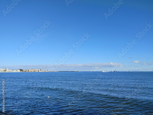 Wide shot of the deep blue sea under a clear blue sky in Sopot
