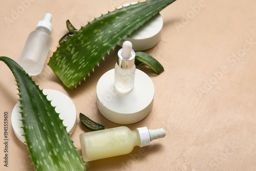 Fresh aloe leaves, bottles ...