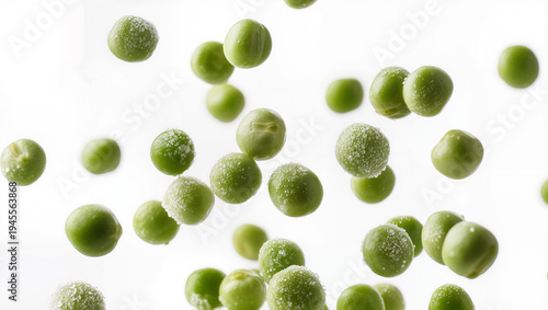 Frozen Green Peas Flying in Air with Ice Crystals on White Background