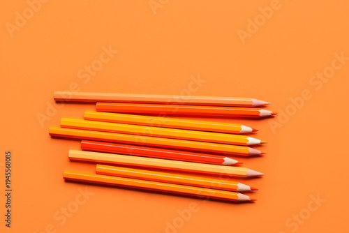 Set of color pencils on ora...
