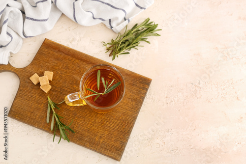 Wallpaper Mural Wooden board with glass cup of hot rosemary tea and sugar on white background Torontodigital.ca