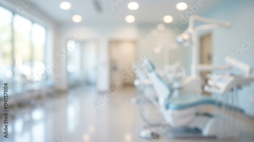 A bright, blurred view of a modern dentist's office features a light blue dental chair and various medical equipment, suggesting a clean and welcoming healthcare environment.