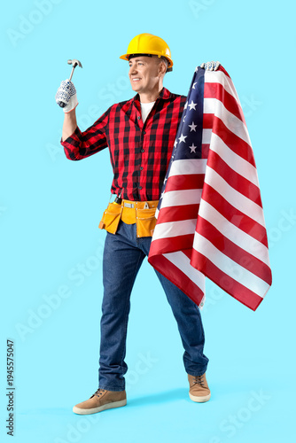 Mature worker with hammer a...