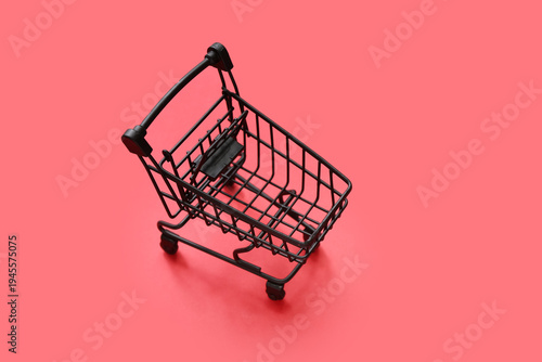 Small shopping cart on red ...