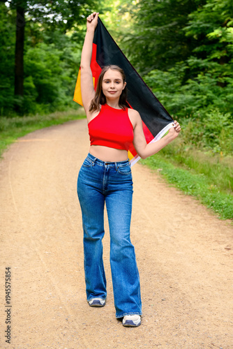 Young woman with flag of Ge...