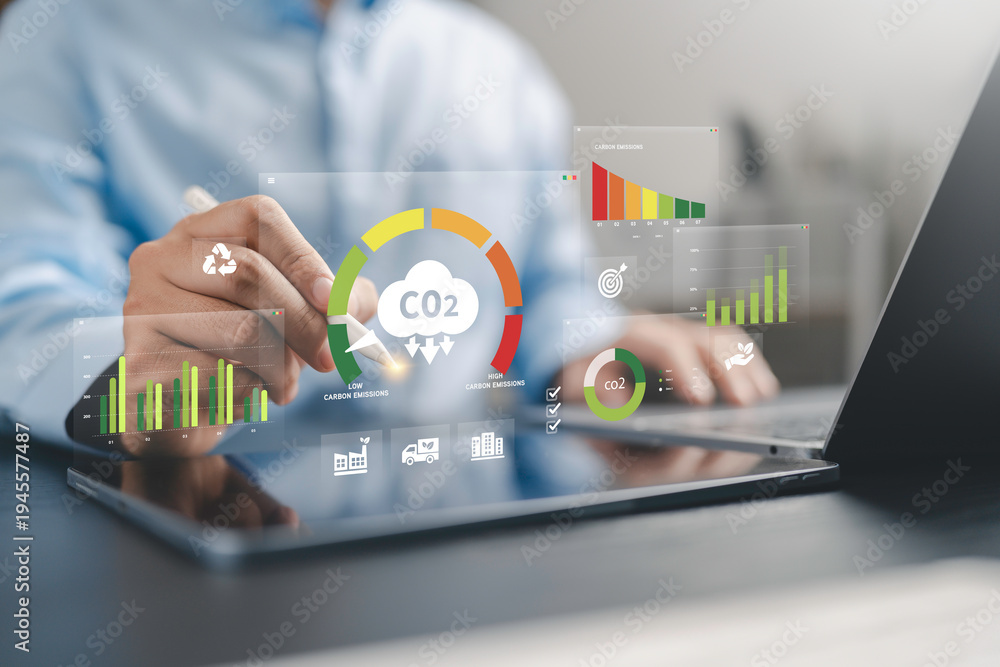 Fototapeta premium Businessman use Carbon emission report dashboard for Reduce levels of greenhouse gas, decarbonize industry, energy and transportation. Lower CO2 emission to limit for Carbon neutral and net zero.