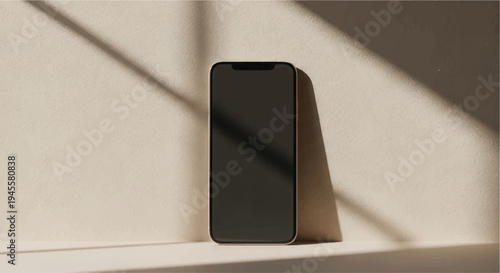 A sleek smartphone with a black screen resting on a light-colored surface.