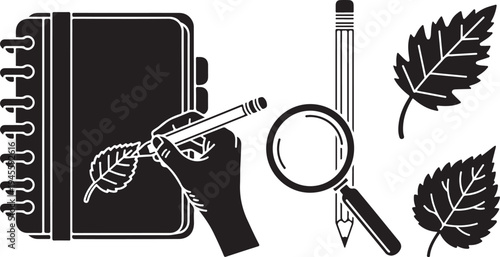 Hand holding leaf with notebook and magnifying tools