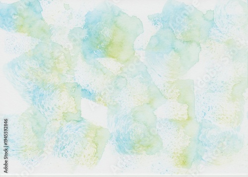 A watercolor background dabbed with a sponge in light blue and light green