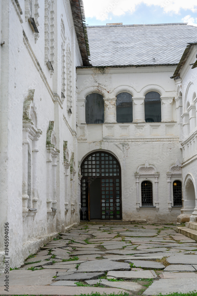 Fototapeta premium Courtyard with buildings of a medieval monastery of the 17th century in the Kremlin in Rostov the Great