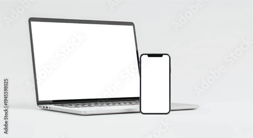 Modern laptop and smartphone on a white surface in a minimalist setting
