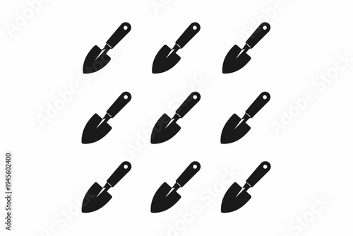Pattern of nine black garden trowels on white background