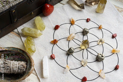 A top view image of a crystal grid for abundance which uses citrine crystals and sacred geometry grid cloth.