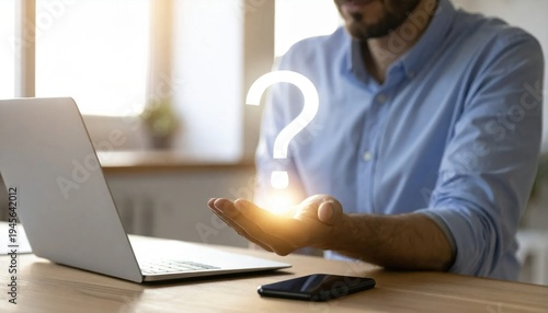 Man Holding Opening Hand with Light Symbolizing Questions and Curiosity at Modern Workspace