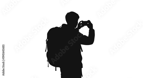 Silhouette of a person with a backpack taking a photo.