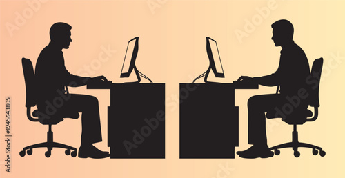 Silhouette of two people working at desks with computers side by side