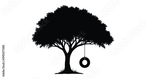 A solitary tree with a tire swing a striking black silhouette