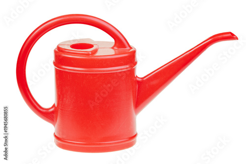 Red plastic watering can isolated on white background representing gardening, plant care and watering plants concept