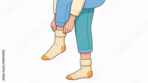 Close up of hands pulling on striped socks with blue pants