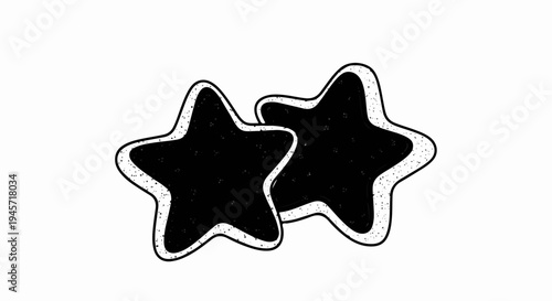 Two cartoonish black star-shaped cookies with white icing outlines