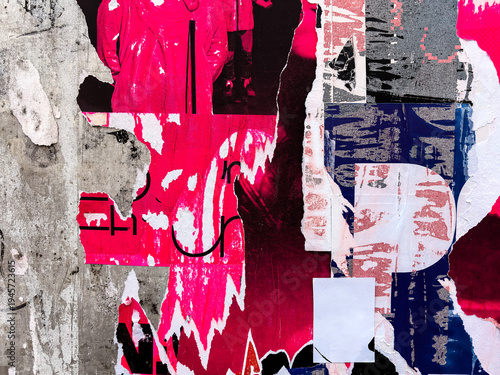 Layers of old colorful posters on wall damaged by time for your grunge style design