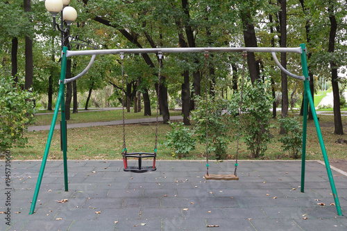 Empty swing set stands in quiet park